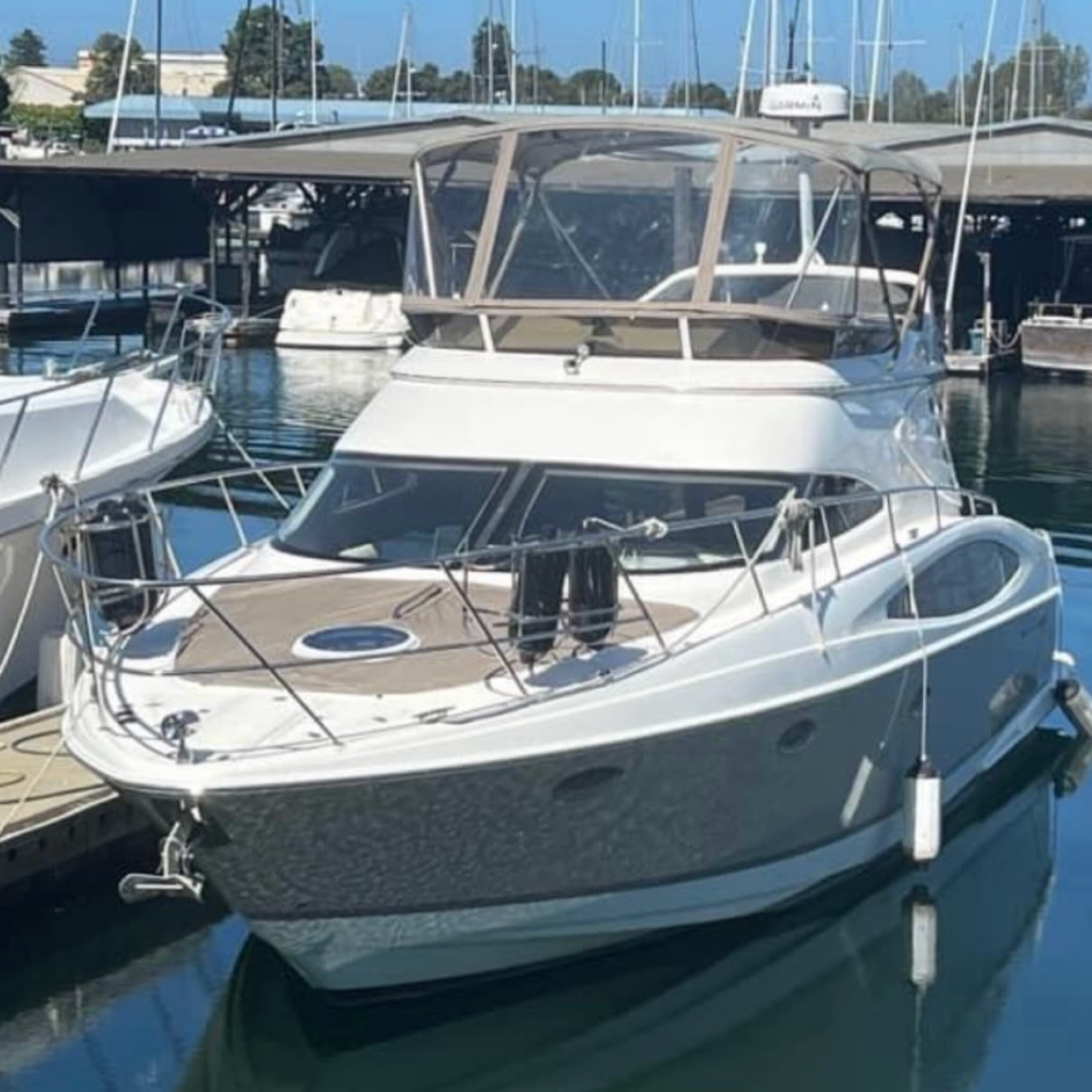 Original photo of a motor yacht docked at a marina